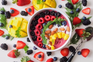 Купа, пълна с вкусна и здравословна храна, състояща се от множество плодове като боровинки, ягоди, малини, ананас и други
